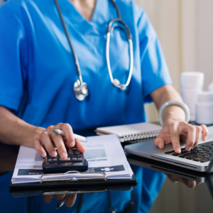 Healthcare team member reviewing financial documents related to common insurance billing problems for medical practices