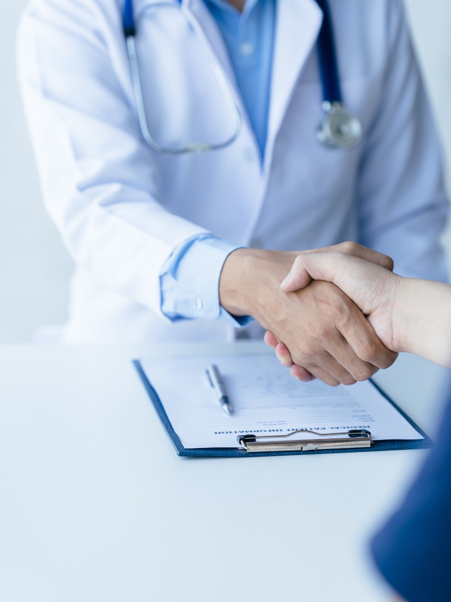 Healthcare provider shaking hands with a patient while discussing medical practice support and billing services in virginia beach and across the united states