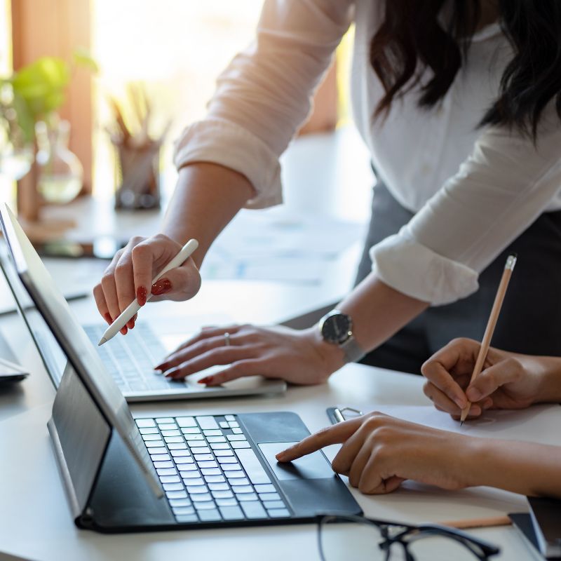 Get-started-expert-medical-consulting Healthcare consulting professionals collaborating on laptops and digital strategy planning for medical practice management