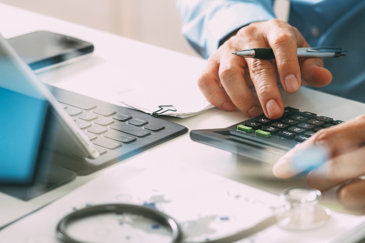 Medical billing specialist calculating healthcare financial data for revenue cycle management services in virginia beach and across the united states