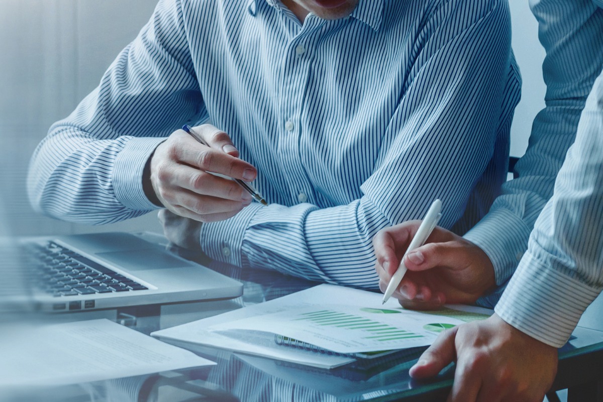 Healthcare billing professionals reviewing financial reports and insurance claim data for medical practice revenue management support.