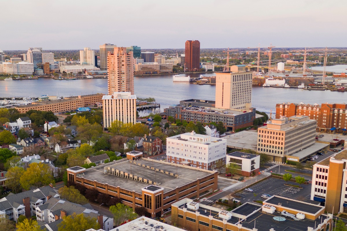 Aerial view of portsmouth and norfolk, virginia waterfront skyline with residential and commercial buildings along the elizabeth river.