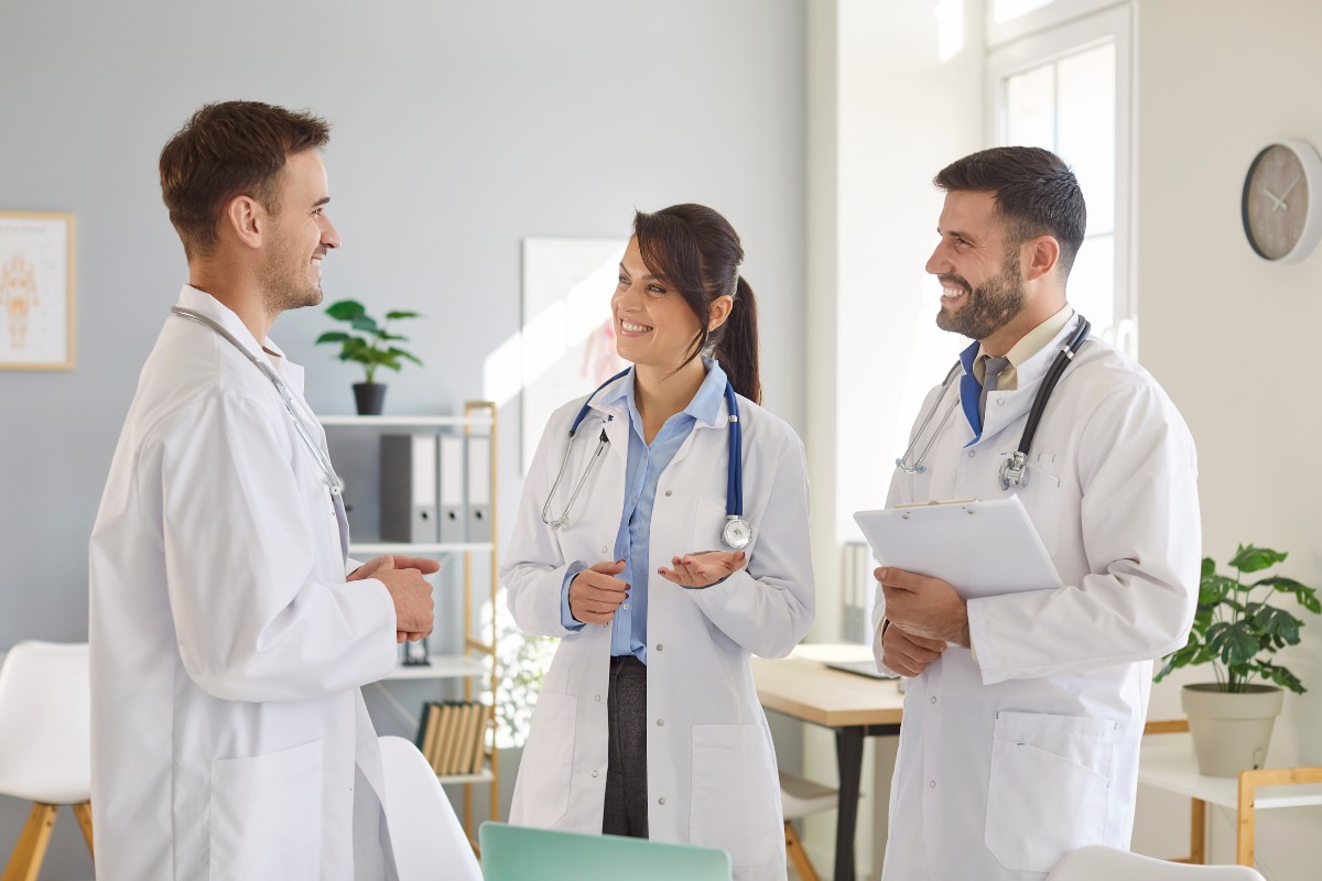 Healthcare providers discussing medical practice operations and administrative support in a modern healthcare office.